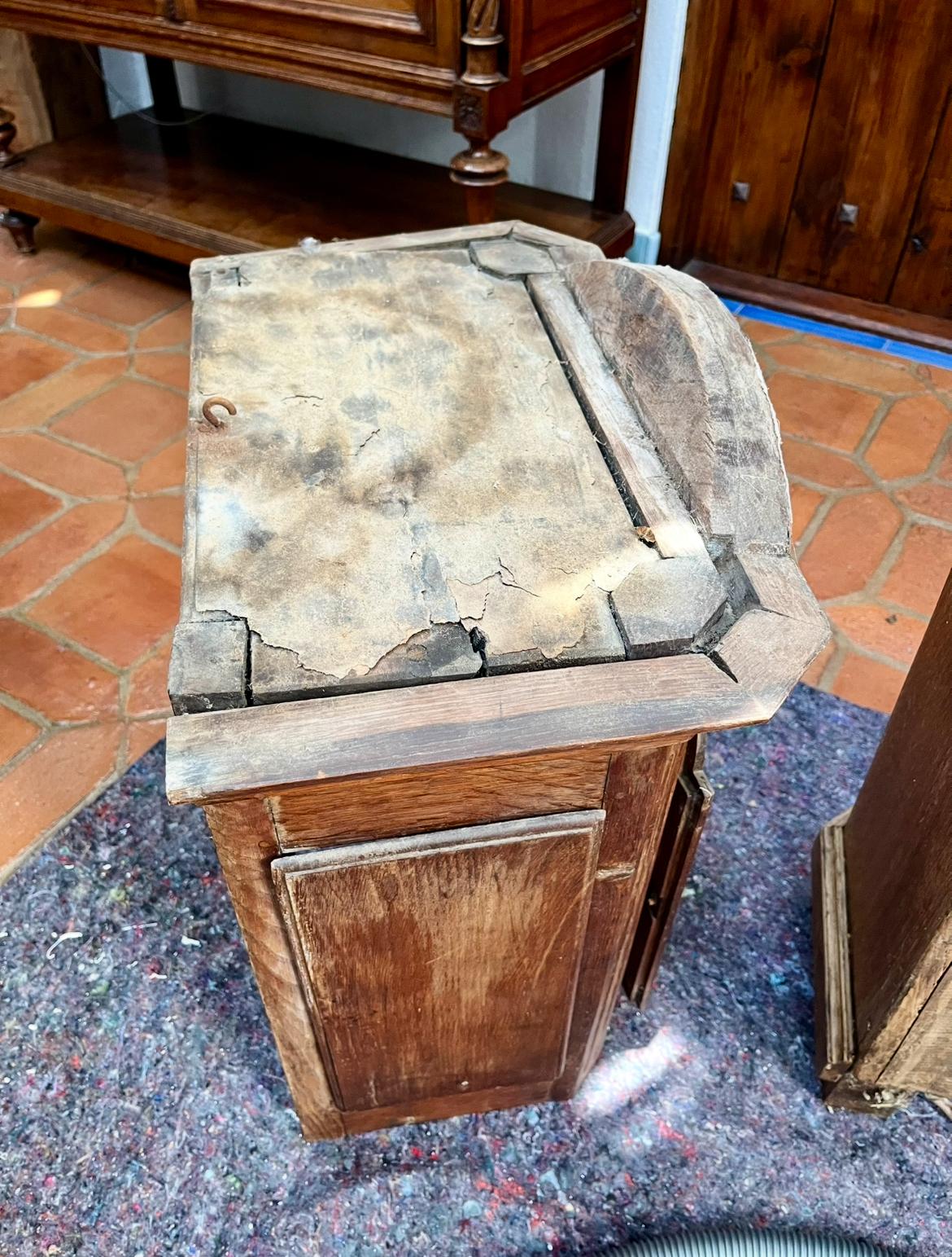 The hood fully removed from the case and set on the floor, with the cracked roof layer visible from above