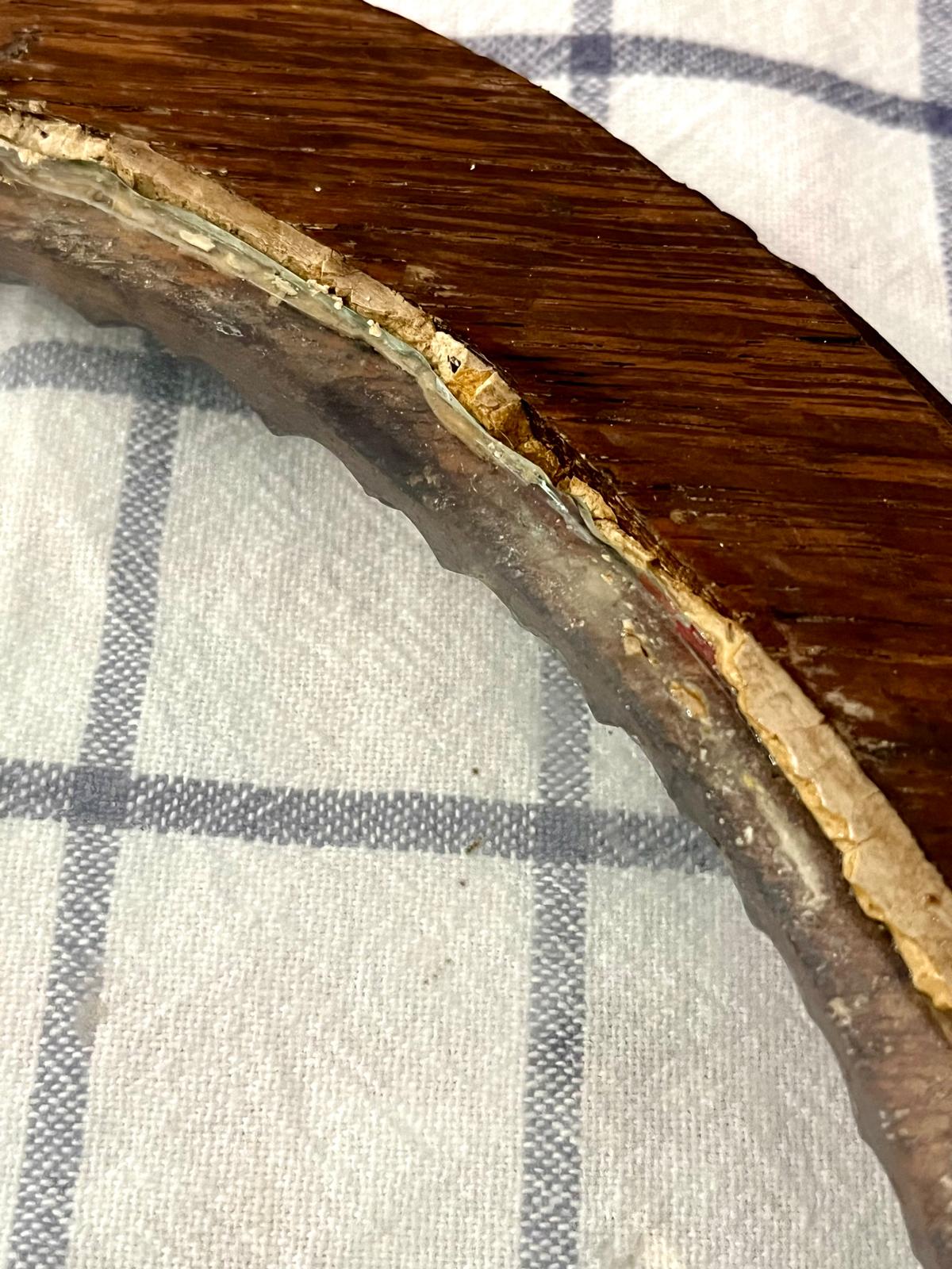 The bright red line of iron red lead, revealed under the layer of putty