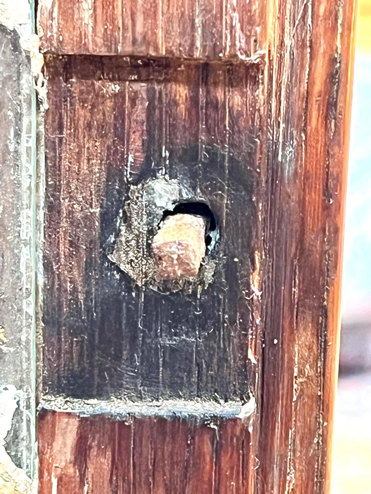 A macro shot of the empty mortise left by the lost lock