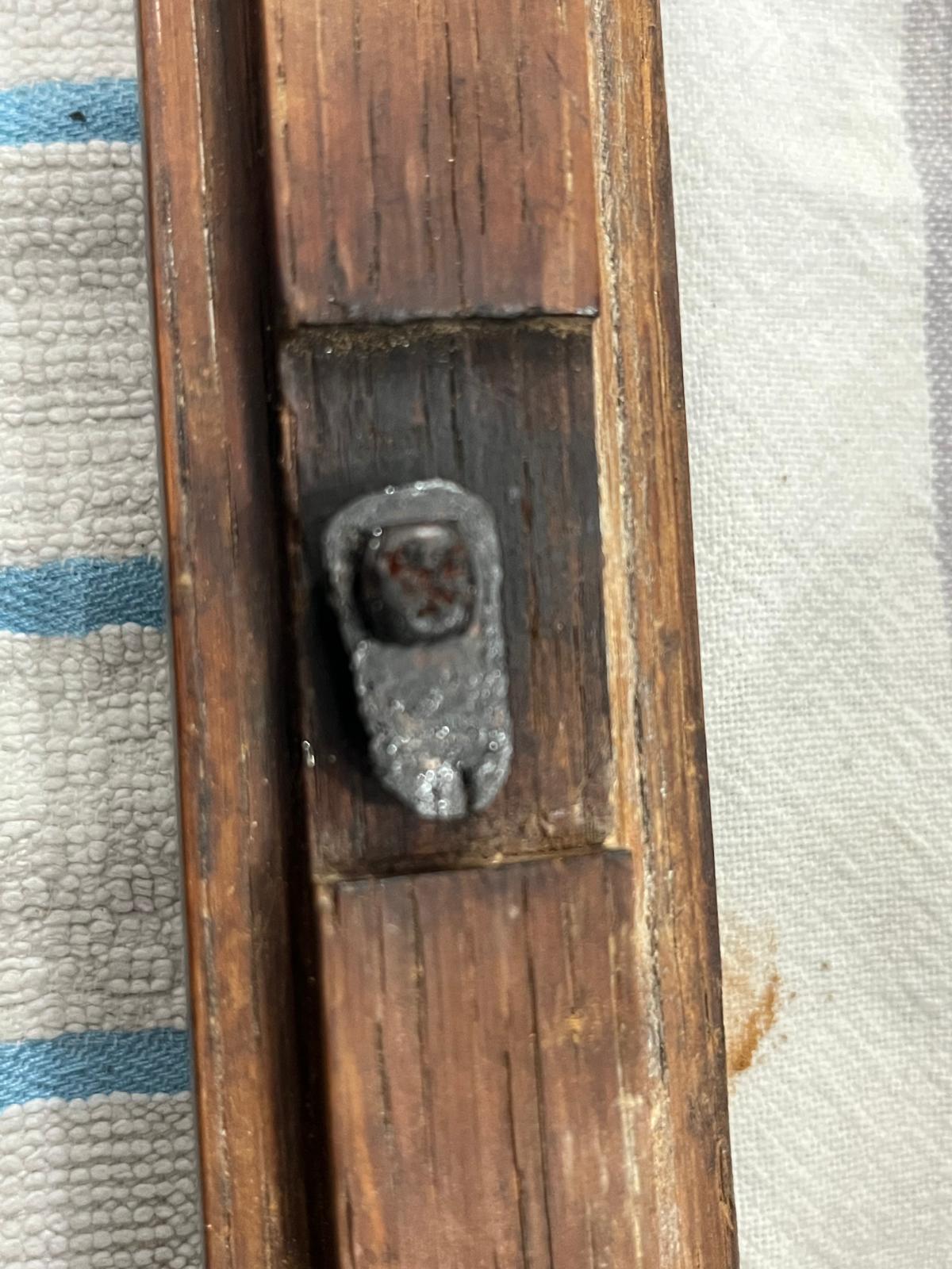 The finished latch after the bitumen coating — the steel has become forged cast iron