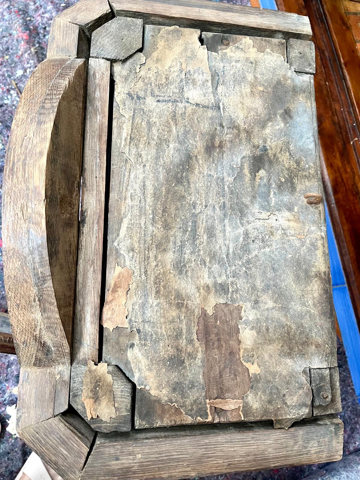 An overall view of the hood's roof with its multi-layered, darkened parchment — the starting condition