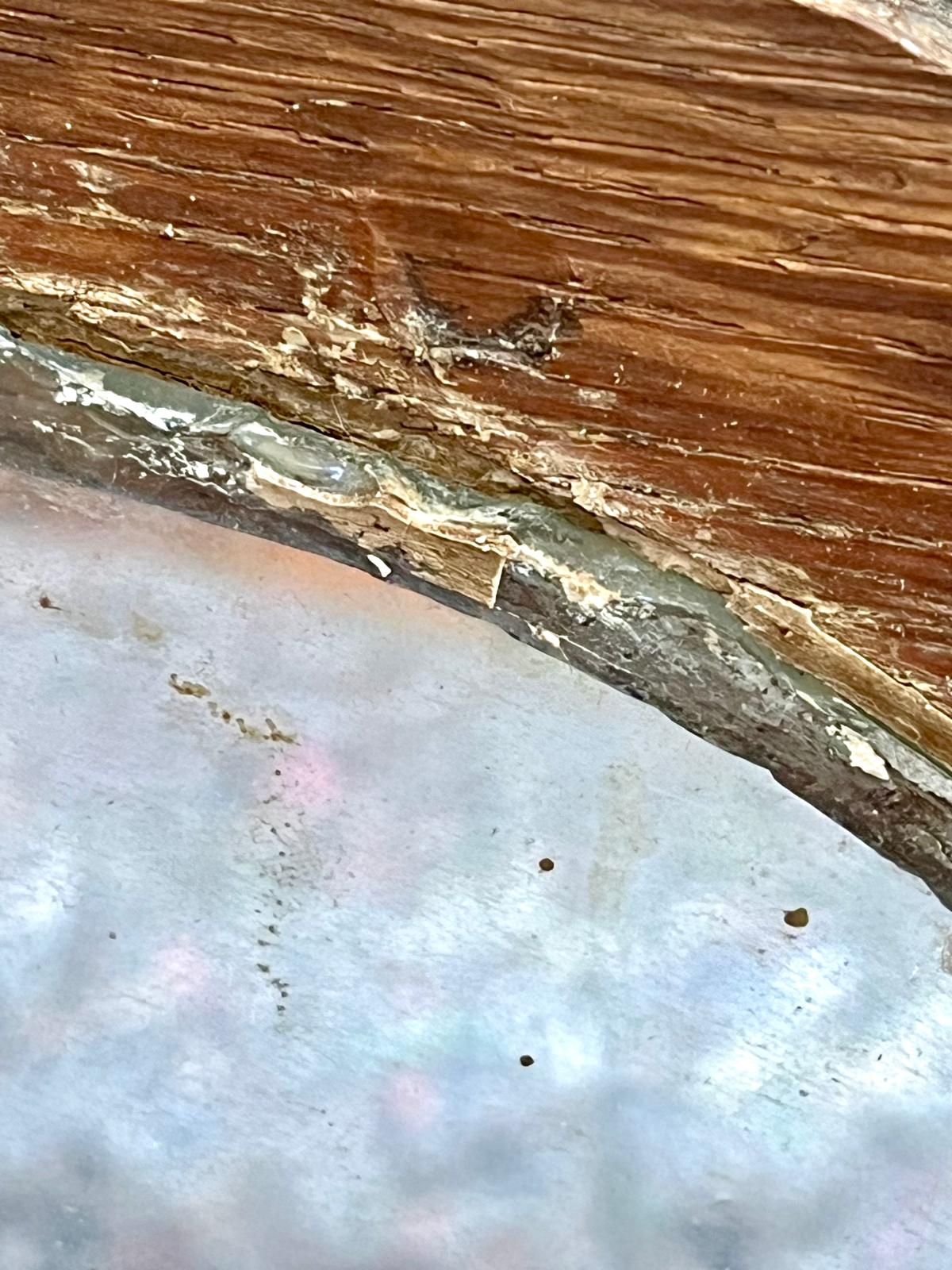 A close-up of the glass-to-wood joint, with remnants of putty and linseed oil
