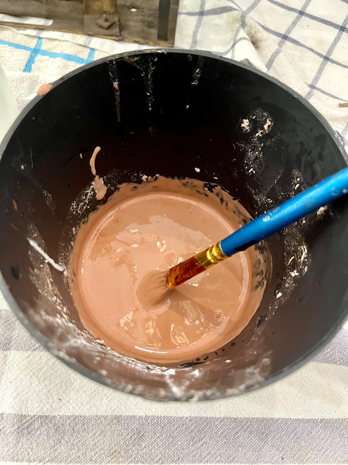 The finished, fully blended, cocoa-colored emulsion