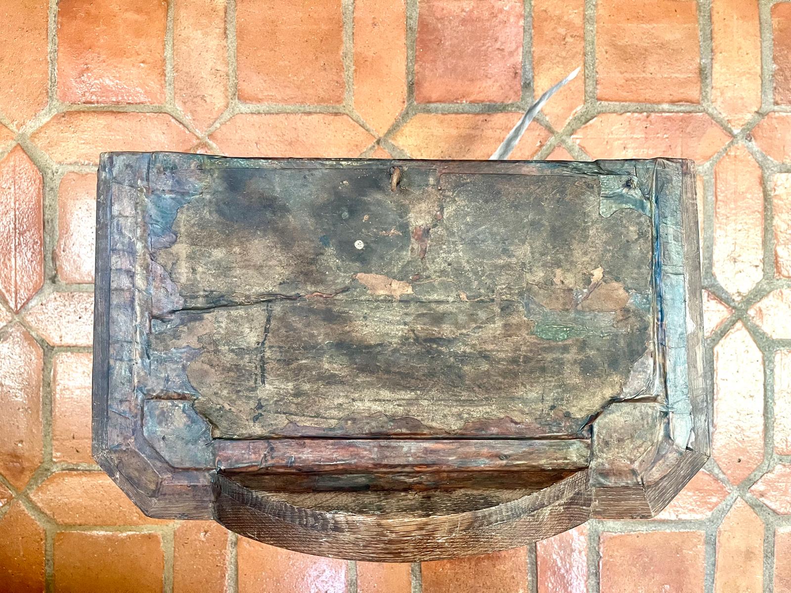 The roof panel on the terrace tiles, with the anchor hook visible at the edge