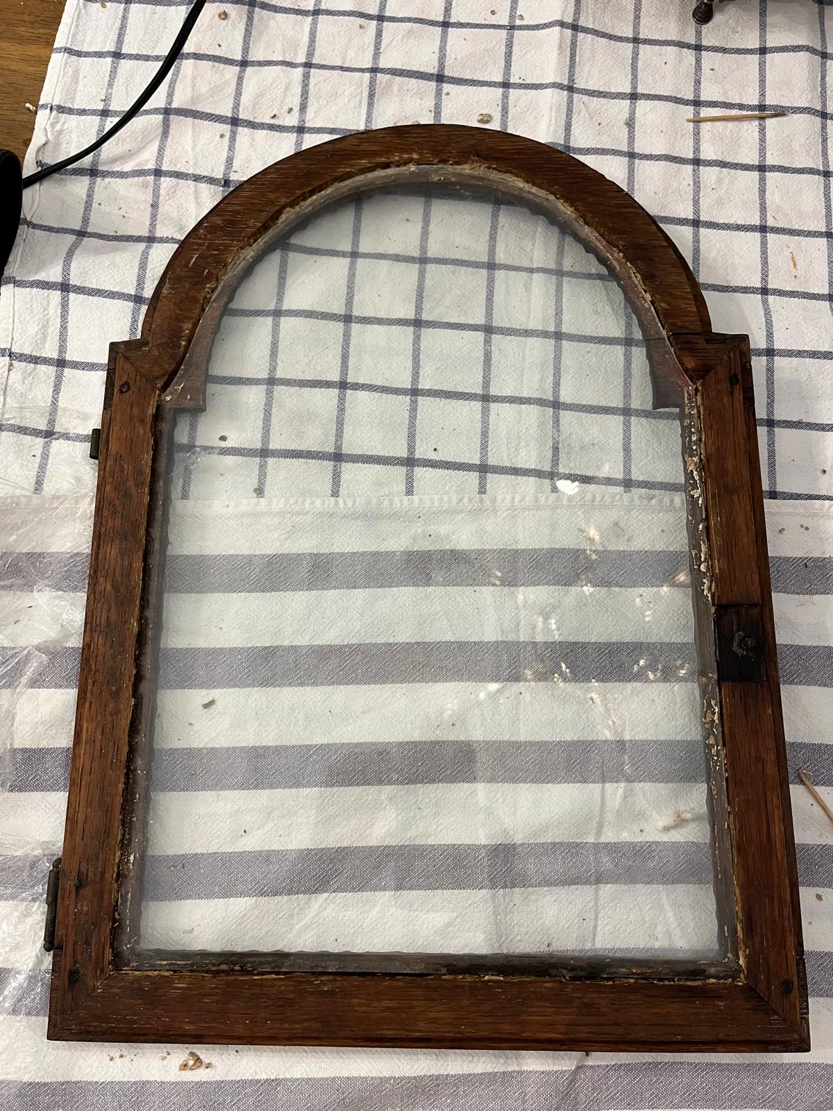 The hood door with its glass still in place, whole, before removal