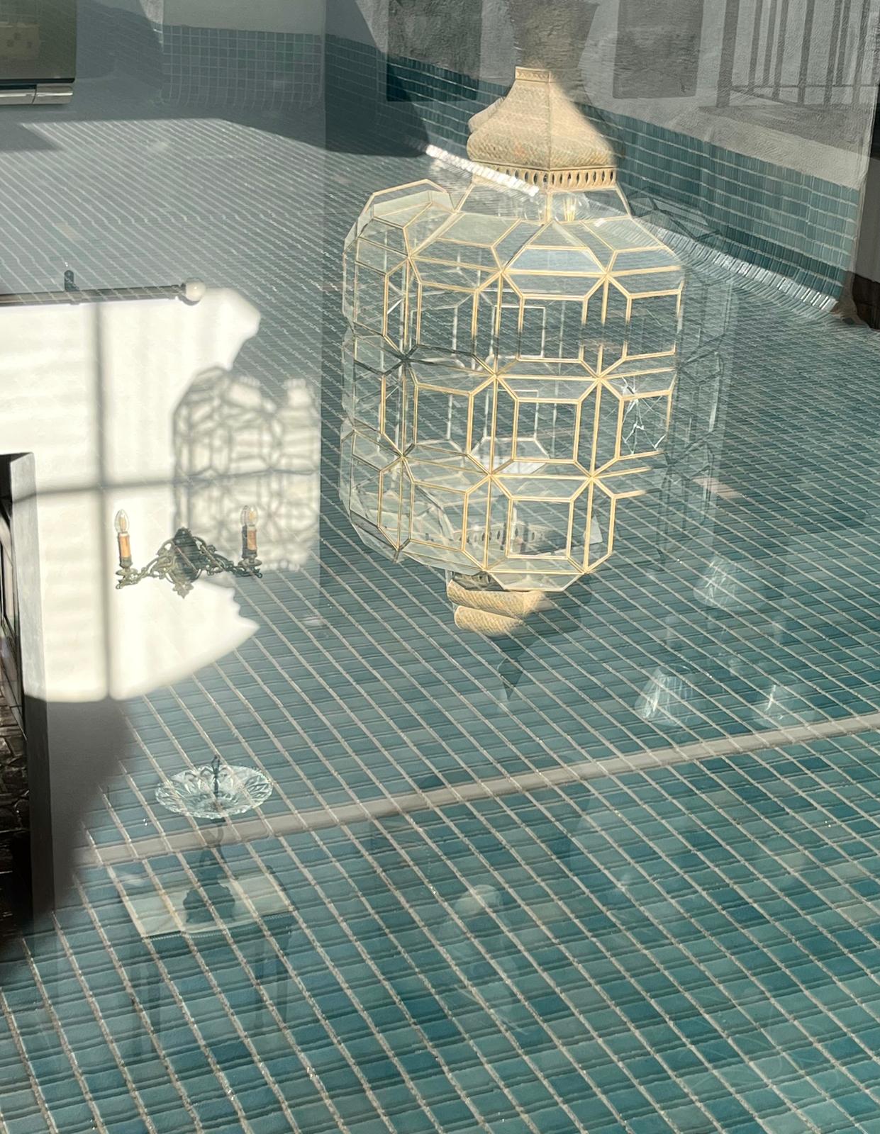 The lantern hovers in the turquoise water — view one