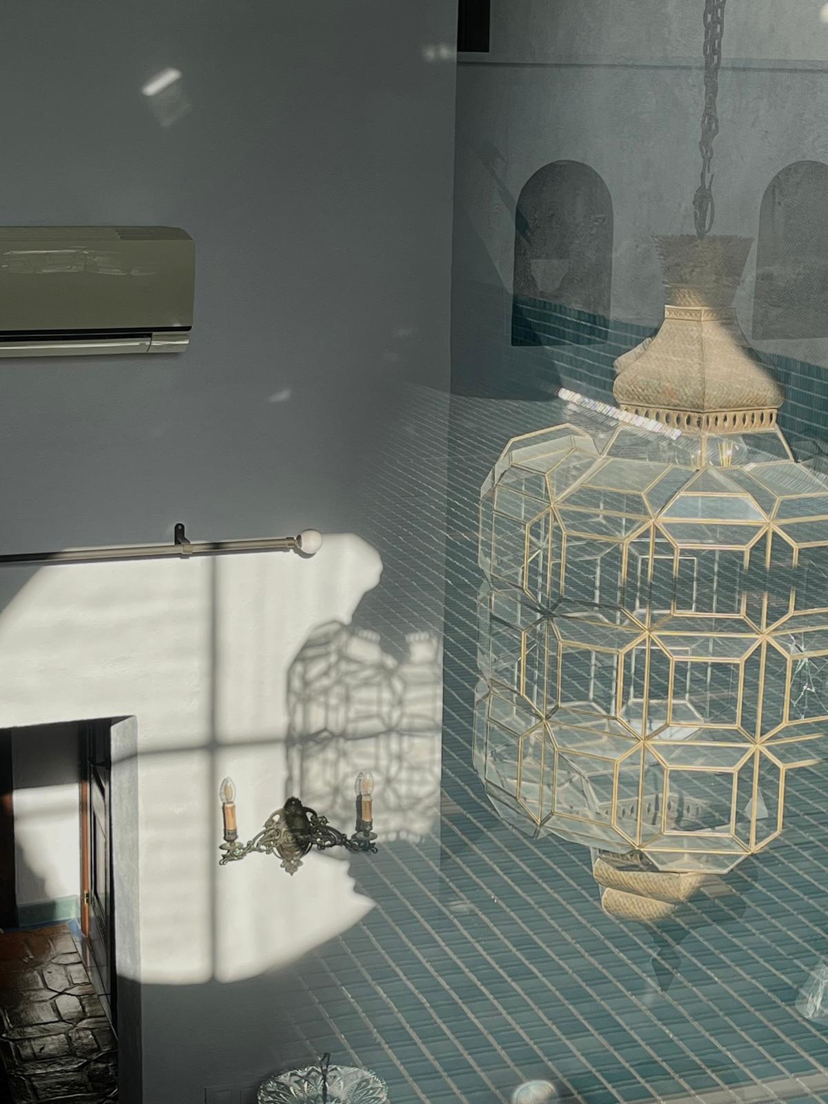 The terrace's reflection overlays the living room — view two