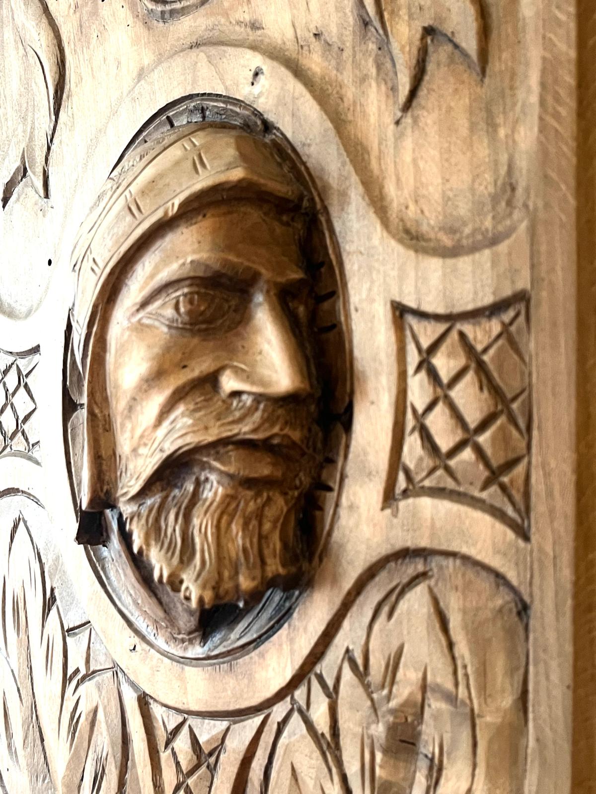 An extreme close-up of the helmeted warrior's face, showing the fine detail of his beard and features