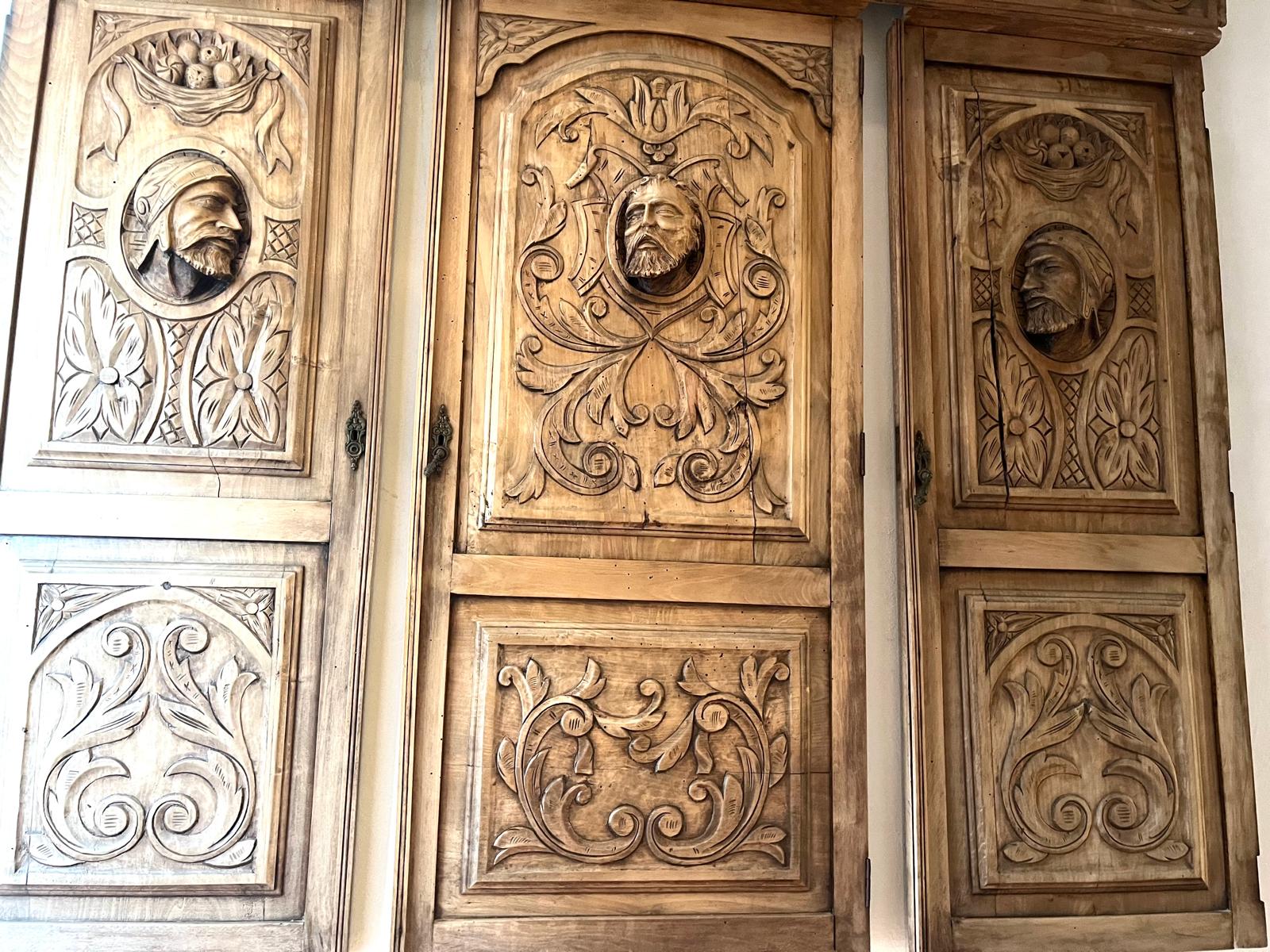 All three panels seen straight on, showing the lower scroll-ornament register on each one