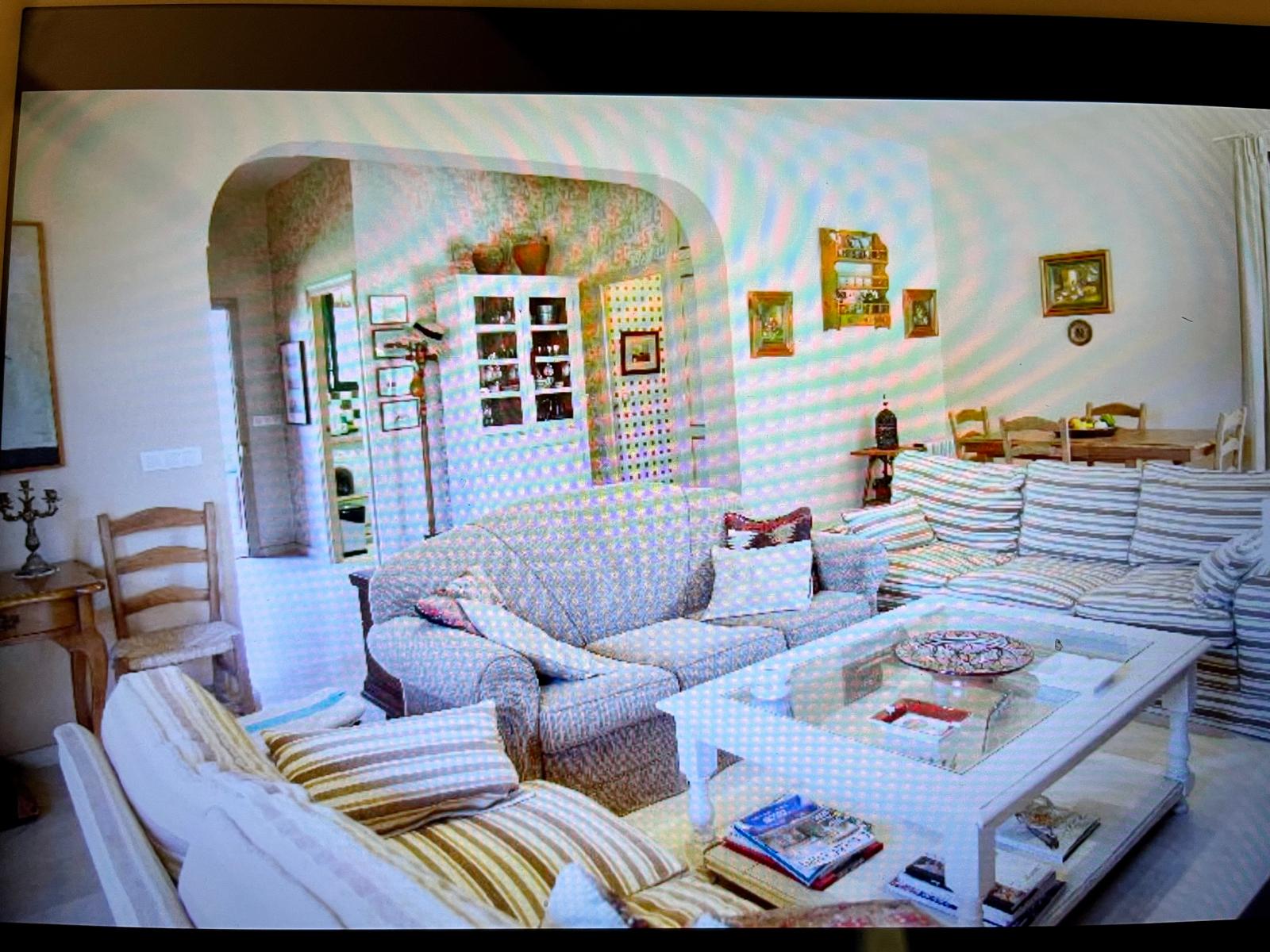 The living room, with the arch leading into the bright kitchen