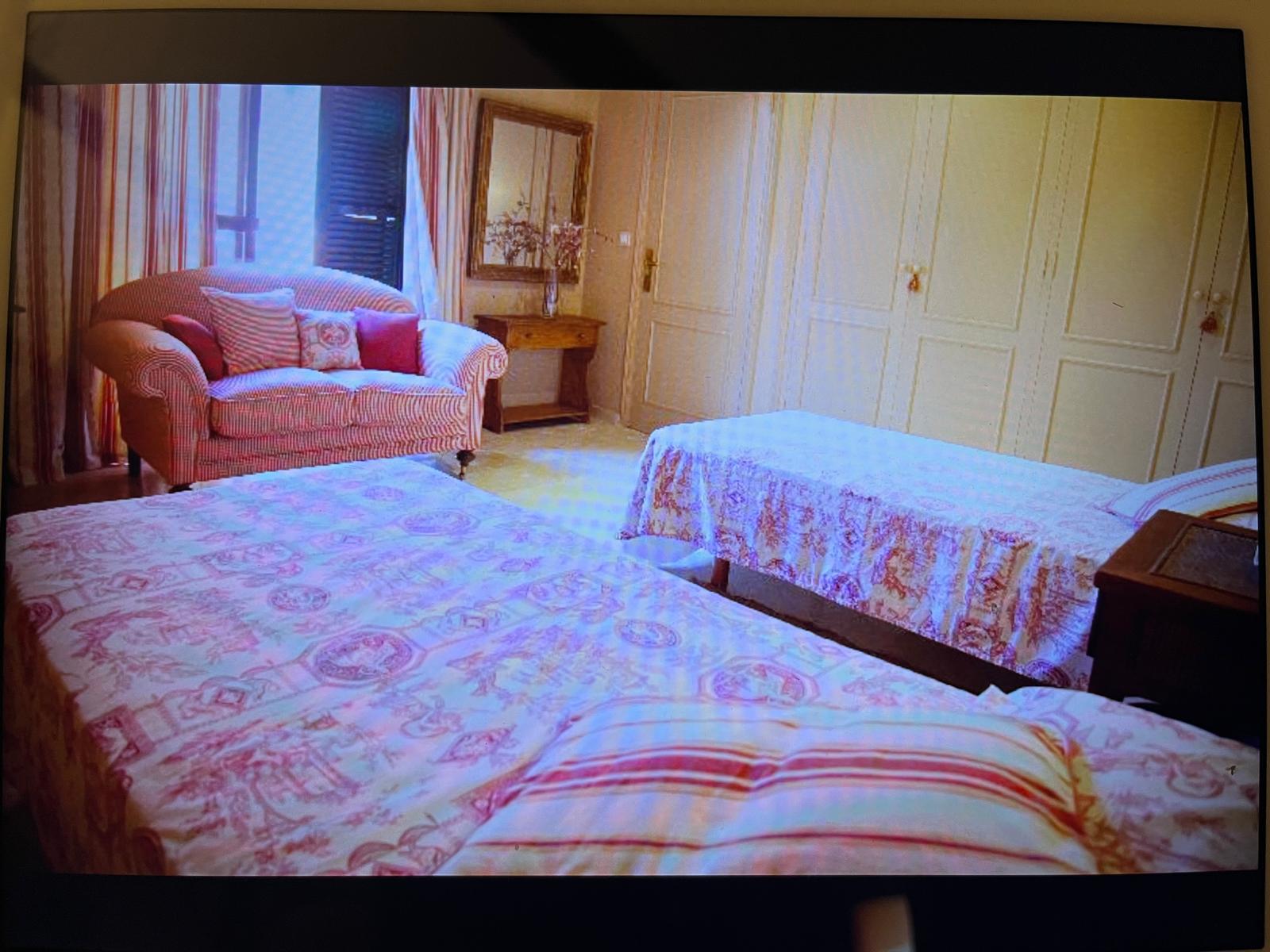 The tiny children's room, with two narrow beds under floral bedspreads