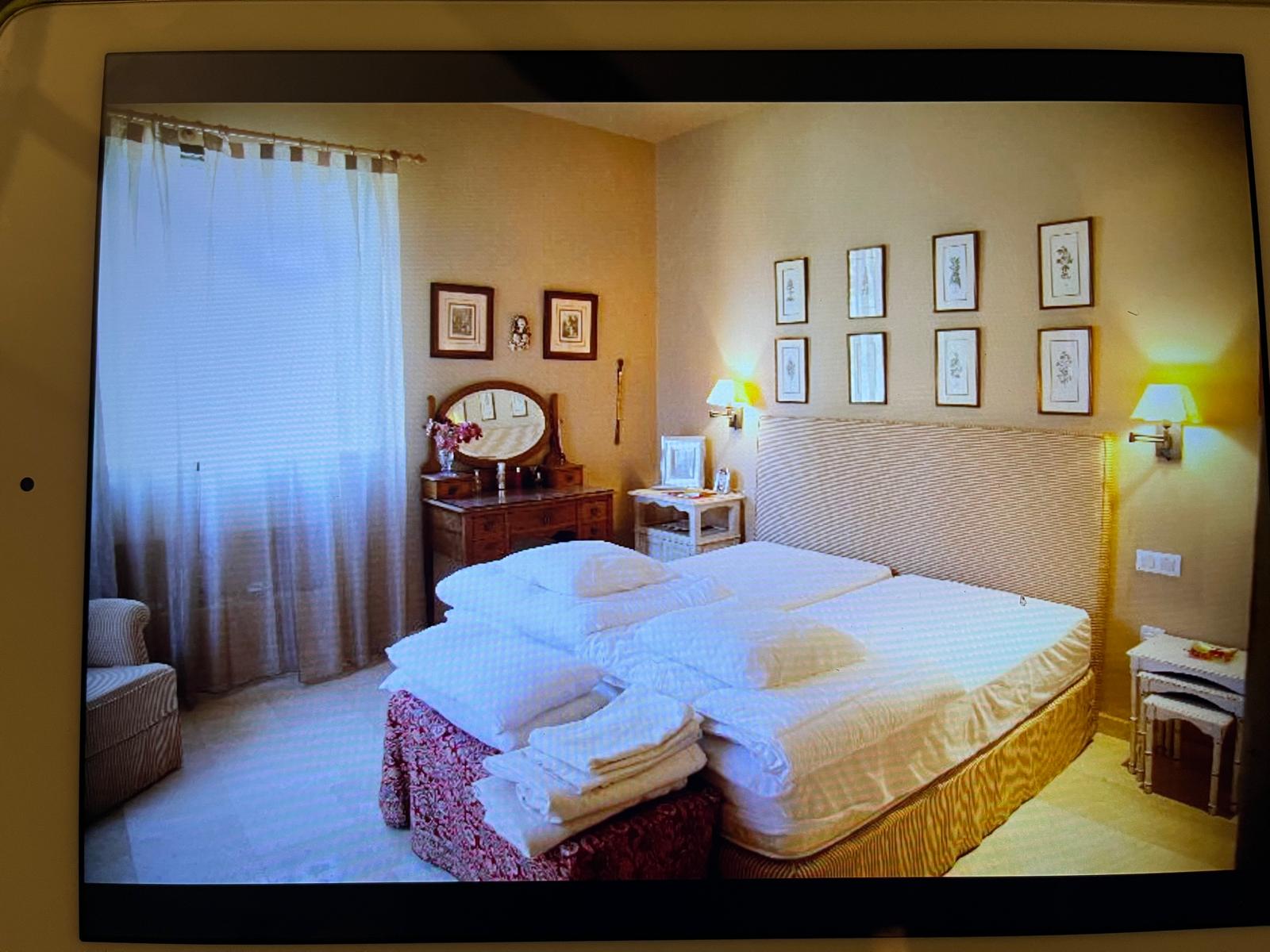 The master bedroom, with its antique wooden vanity by the window