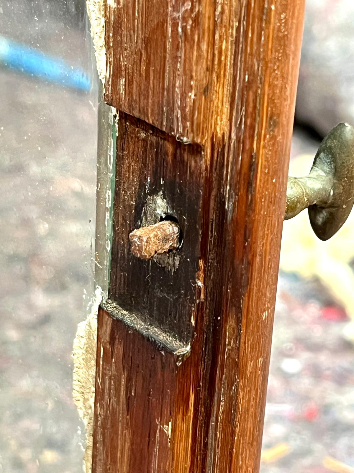 A forged, faceted pin jammed in its frame, with an empty socket where the lost locking tongue used to be