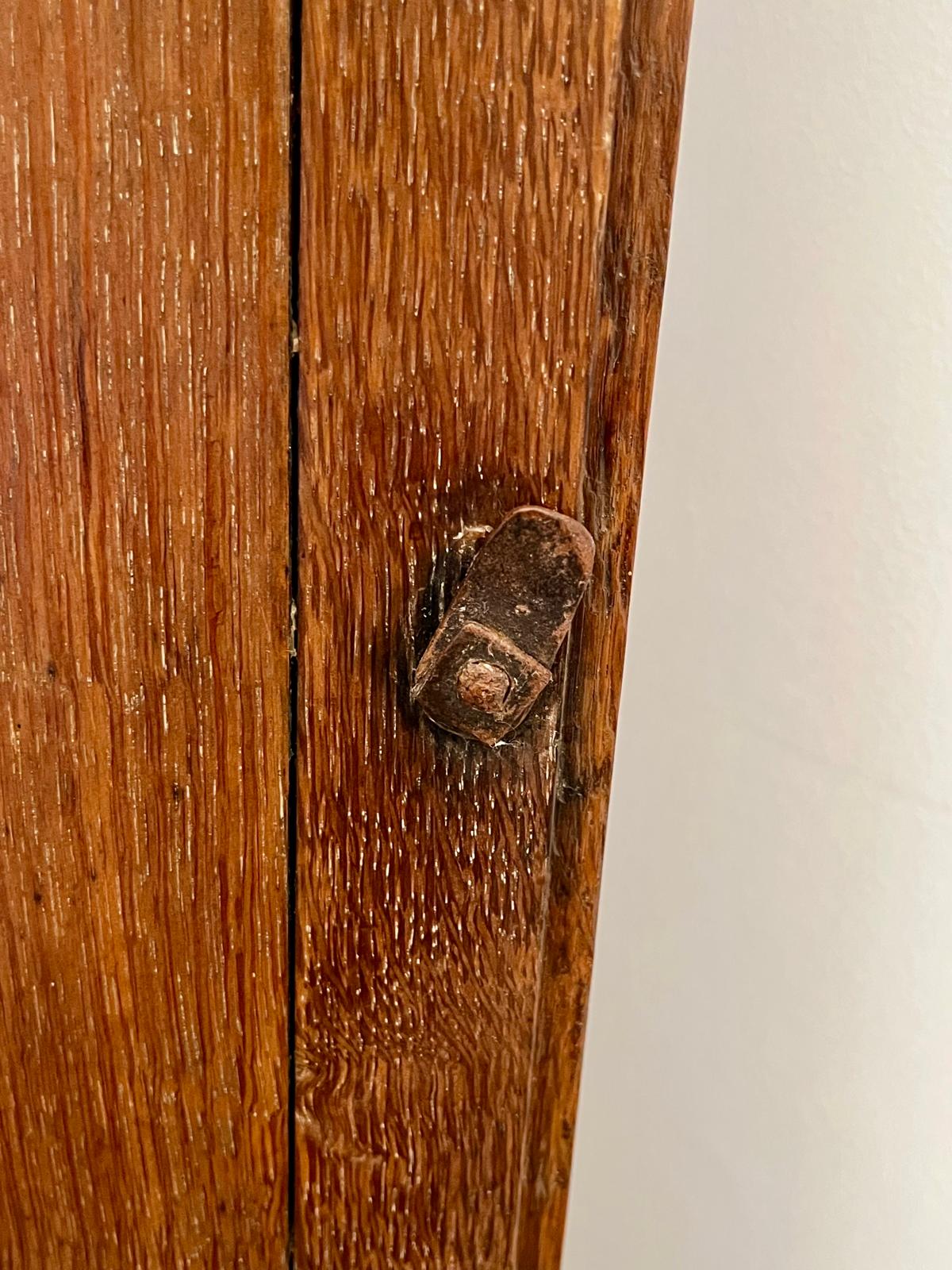 The historical original latch on the clock's adjacent inner panel